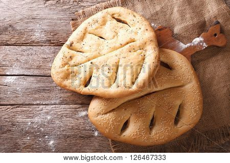 Fugasse French Bread Closeup On The Table. Horizontal Top View, Rustic