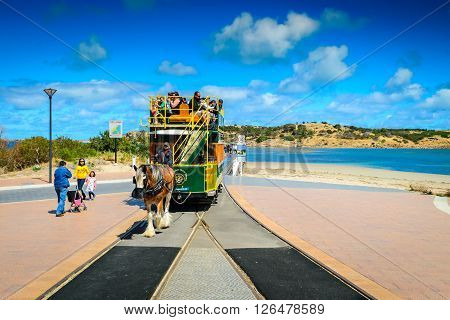 Adelaide Australia - November 16 2013: The Victor Harbor Horse Drawn Tram with people on board arriving from the Granite Island on a day