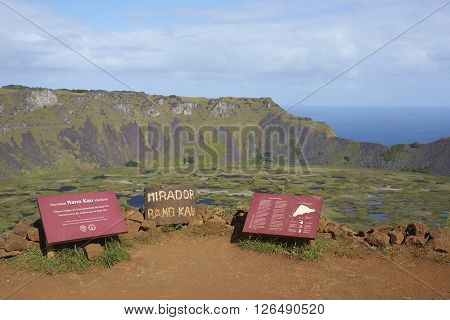 EASTER ISLAND - APRIL 6, 2016: Information signs on the edge of the caldera of the extinct volcano Rano Kau within the UNESCO World Heritage Site of Rapa Nui National Park on Easter Island.