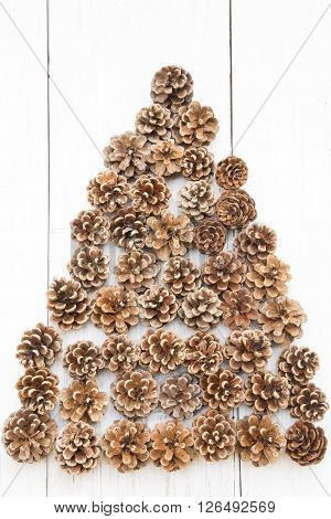 Pine cones on a white wooden background