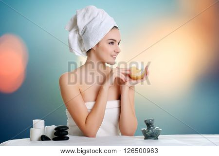 Young spa woman touching her face after beauty treatment