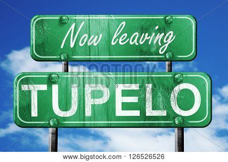 Now leaving tupelo road sign with blue sky