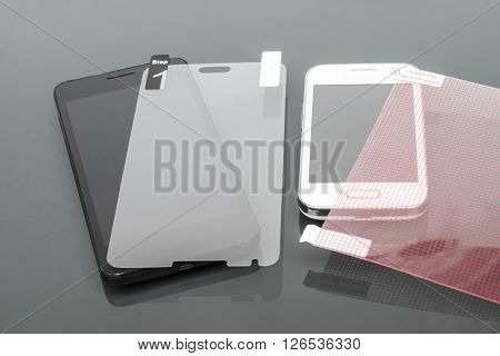 a scratch protective film on a smartphone /  smartphone care and maintenance concept