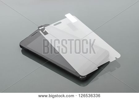 a scratch protective film on a smartphone /  smartphone care and maintenance concept