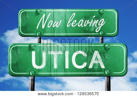 Now leaving utica road sign with blue sky