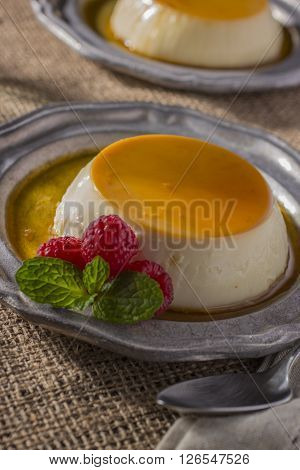 Two Dessert Plates with Caramel Flan and Raspberries