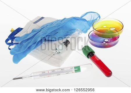 Biochemistry Research of blood tests. Cell culture for the biomedical diagnostic. Gloves,  petri dish for blood analysis,  Plastic labware for scientific research and personal protection equipment.