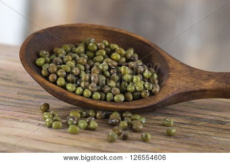 Soya bean pulses in a wooden spoon and scattered