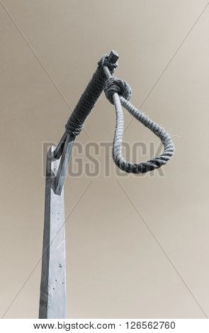 Gallows and hangman noose against a dark sky