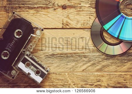 audio cassettes and CD discs on a wooden table