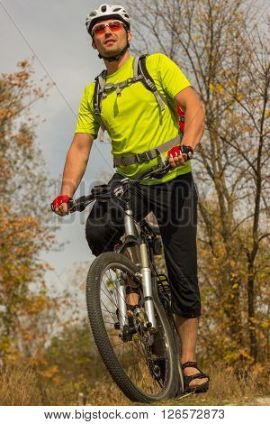 Male cyclist traveling with bike and backpack.