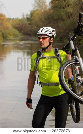 Male cyclist traveling with bike and backpack.