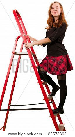 Beaytiful teen girl in checkered skirt standing on stepladder