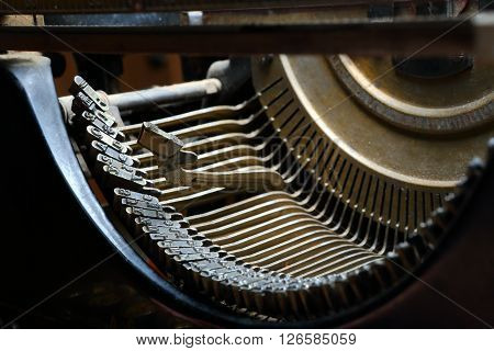 Part of old typewriter printing machinery - striking hammer with the letter