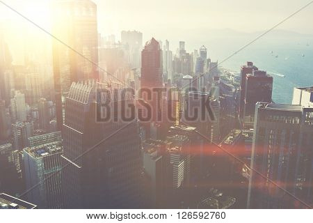 View from the roof on a modern business center in New York with office commercial and residential buildings with contemporary architecture. Developed metropolitan city with tall skyscrapers near sea