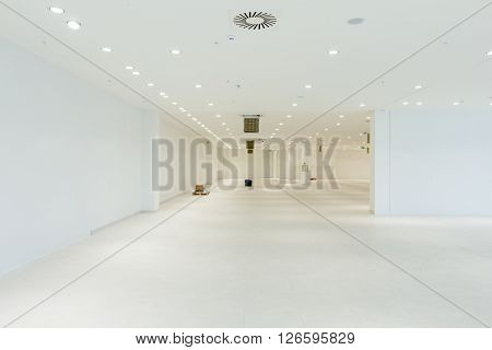 Interior of empty unfinished modern mega market. Architecture concept. Empty white room has white walls.