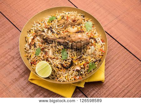 authentic chicken biryani with leg piece, prepared in basmati rice