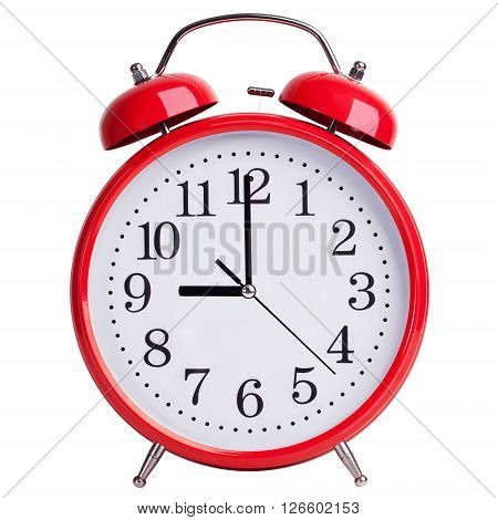 Round red alarm clock shows exactly nine o'clock