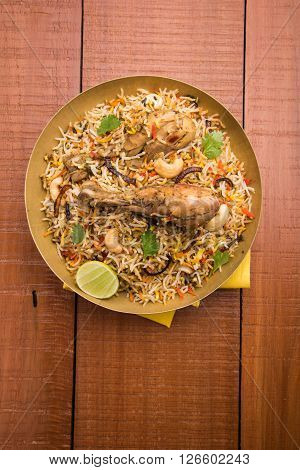 authentic chicken biryani with leg piece, prepared in basmati rice
