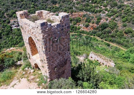 Watchtower remains of outer walls of castle Monfort in northern Israel and the path leading to the castle