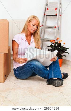 woman with plan in new apartment