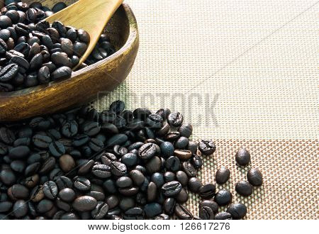 coffee beans and wooden bowl  on table