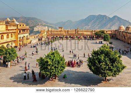 AMER, INDIA - NOVEMBER 18, 2012: Tourists visiting Amer (Amber) fort, Rajasthan, India. Amer fort is famous tourist destination and landmark