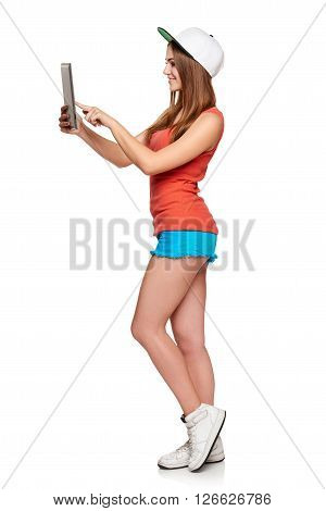 Full length sporty female with digital tablet over white