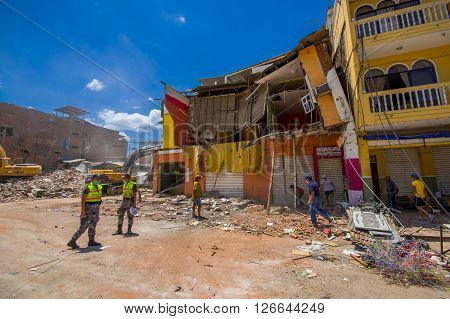 Portoviejo, Ecuador - April, 18, 2016: People gathering their belongings from building showing the aftereffect of 7.8 earthquake that destroyed the city center, and most of the Manabi province.
