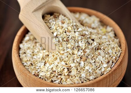 Oatmeal Or Oat Flakes In Bowl And Scoop On Dark Wooden Table