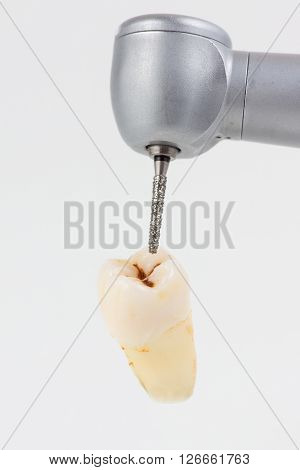 dentist using dental turbine handpiece for dental treatment