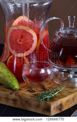 still life of red tea , shisha , pears on a wooden stand