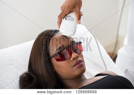 Therapist Giving Laser Epilation Treatment To Woman