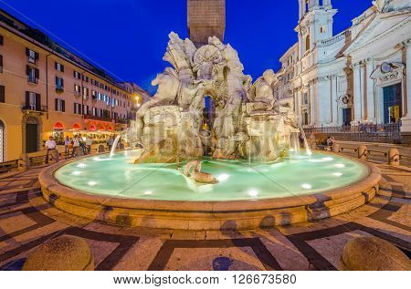 Illuminated at night the Fiumi Fountain on Piazza Navona, Rome, Italy.