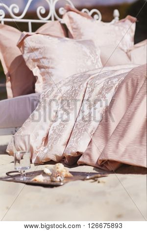 Still life details Cozy interior details soft and warm home decor. Colorful pillows on a sofa with little vase