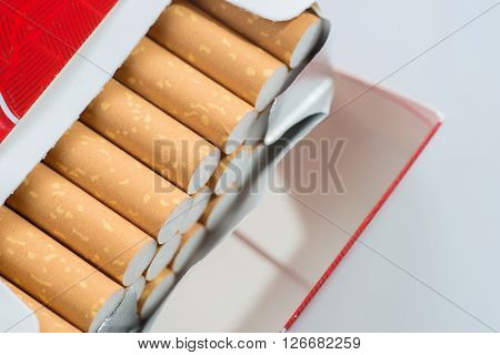 Open pack of cigarettes isolated on white background