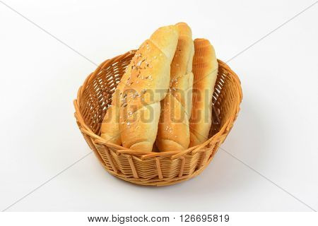 scuttle of fresh rolls with salt and caraway seeds on white background