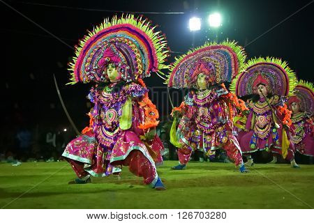 BAMNIA PURULIA WEST BENGAL INDIA - DECEMBER 23RD 2015 : Four dancers performing at Chhau Dance festival. It is a very popular Indian tribal martial dance performed at night amongst spectators.