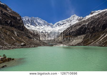 Llaca lagoon (4474 m) in the peruvian Andes and Ocshapalpa peak (5888 m) and Ranrapalca peak (6162 m) Peru