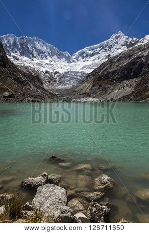 Llaca lagoon (4474 m) in the peruvian Andes and Ocshapalpa peak (5888 m) and Ranrapalca peak (6162 m) Peru