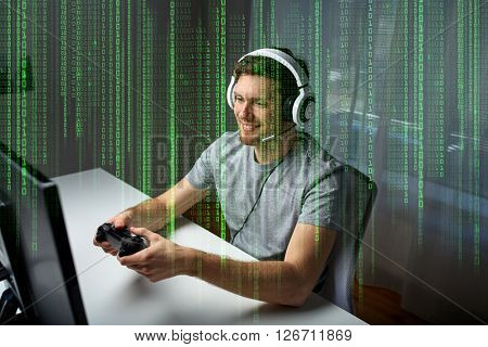 technology, gaming, entertainment, let's play and people concept - happy young man in headset with controller gamepad playing computer game at home and streaming playthrough or walkthrough video