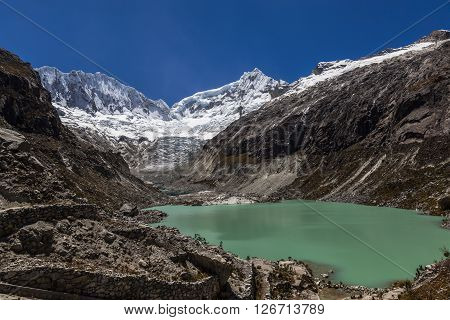Llaca lagoon (4474 m) in the peruvian Andes and Ocshapalpa peak (5888 m) and Ranrapalca peak (6162 m) Peru