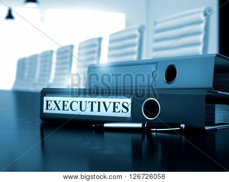 Binder with Inscription Executives on Office Table. Executives - Ring Binder on Office Desktop. Toned Image. 3D Rendering.