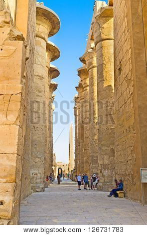 LUXOR EGYPT - OCTOBER 7 2014: The way among the rows of giant columns of the Hypostyle Hall in Karnak Temple on October 7 in Luxor.