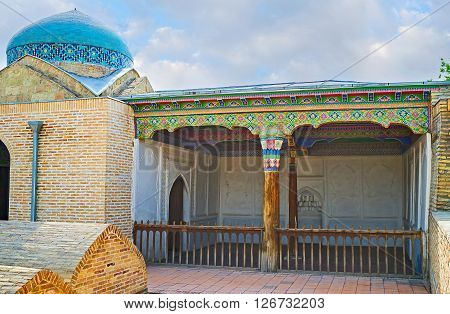 KOKAND UZBEKISTAN - MAY 6 2015: The courtyard of Damoi Shakhon Shrine with the sarcofagi and small Iwan for pray on May 6 in Kokand.