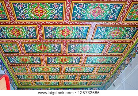 KOKAND UZBEKISTAN - MAY 6 2015: All the rooms in Khudayar Khan Palace boasts unique ceilings' decorations including carvings and painted patterns with floral geometric stellar motives on May 6 in Kokand.