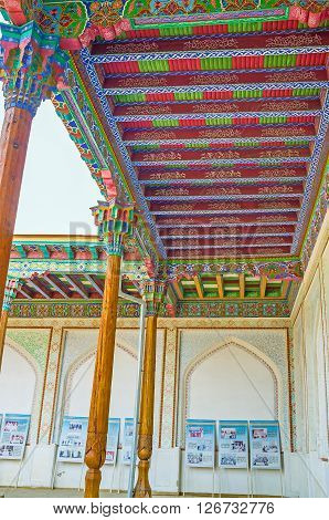 KOKAND UZBEKISTAN - MAY 6 2015: The wooden roof in courtyard covered by beautiful ornaments on May 6 in Kokand.