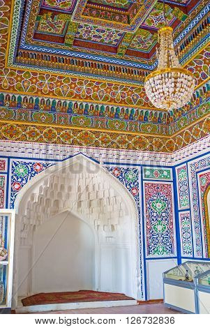 KOKAND UZBEKISTAN - MAY 6 2015: The interior of the Khudayar Khan Palace with the carved niche for the throne on May 6 in Kokand.
