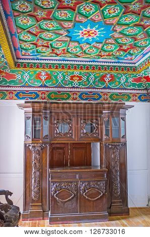 KOKAND UZBEKISTAN - MAY 6 2015: The interior of the residential room in Khudayar Khan Palace with the old wooden furniture on May 6 in Kokand.