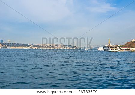 The blue waters of Bosphorus with the public ferry on the background Istanbul Turkey.
